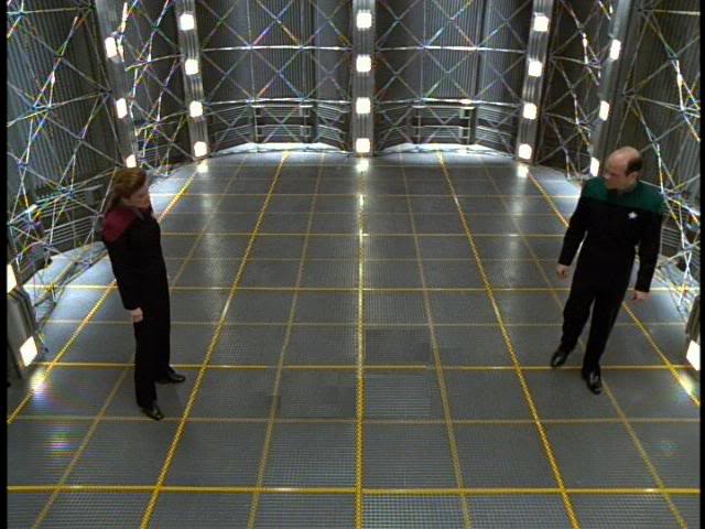 Image is of Star Trek Voyager's holodeck. In the image appears Voyager's Captain Janeway and the Emergency Medical Hologram known as The Doctor